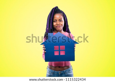 portrait of american african girl holding house