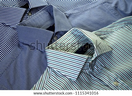 more elegant business shirts on each other background 