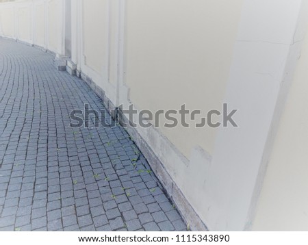 Large concrete wall. Rounded. Cobbles. Background.