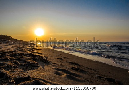 Sea landscape at sunset with reflection seen from the shore of the sea