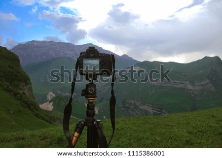 Camera on a tripod, shooting mountains scenery