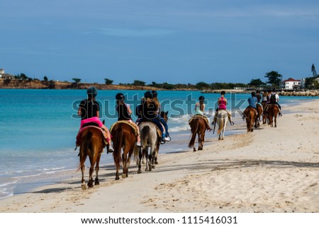 Group of tourists horseback riding on the beach in Antigua Island,

Day at the beach in St.John, Antigua & Barbuda Island, Caribbean. Royalty-Free Stock Photo #1115416031