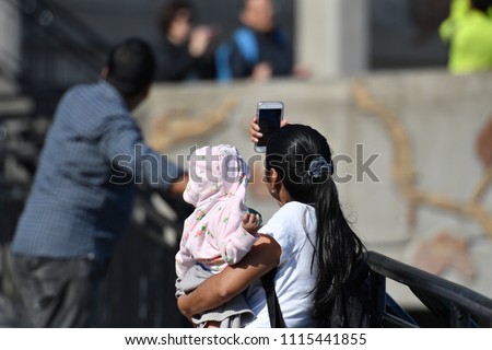 A young mother takes a selfie near the Niagara-falls in Canada