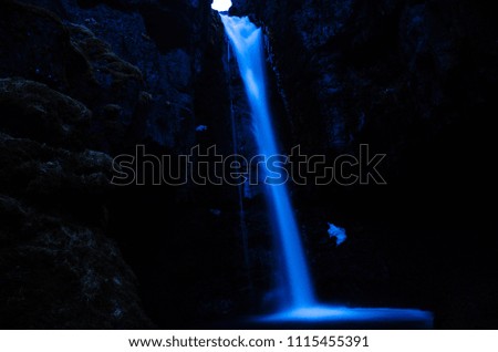 Waterfall at night with snow in Iceland