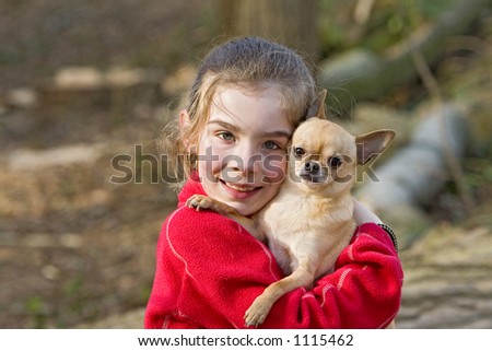 Girl hugging her Chihuahua dog