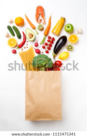 Photo of paper bag with vegetables, fruits, fish and spaghetti