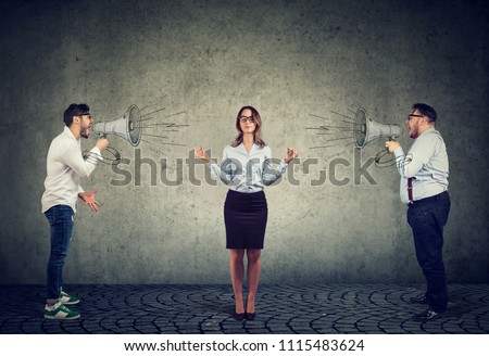 meditating young businesswoman paying no attention to two angry men screaming at her in megaphone Royalty-Free Stock Photo #1115483624