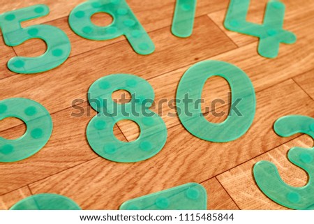 Green numbers on a wooden floor