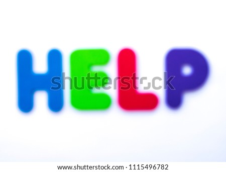 The word HELP blurred over a white background.