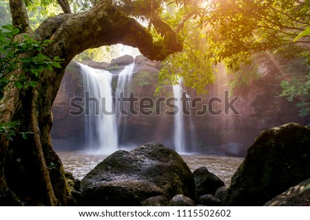 Beautiful waterfall with sunlight in jungle, Haew Suwat Waterfall. Royalty-Free Stock Photo #1115502602