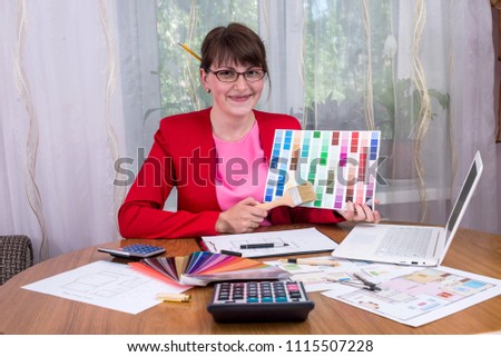 Creative designer with pencils in hair showing colour palette