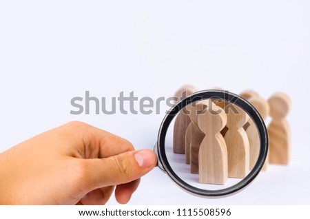 People stand in the formation of the pins. A game of bouwling. Wooden figures of persons, on a white background. The concept of business management personnel and the achievement of goals.