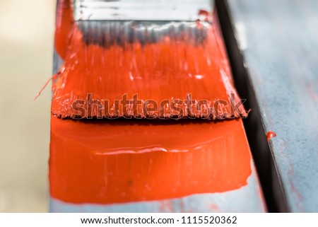 closeup of a color brush during the painting metal equipment   