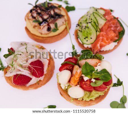 four different bruschettes with salmon, mackerel, shrimp and halibut.