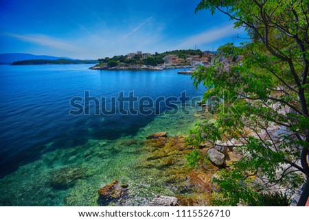 View of Kassiopi Bay, Bataria Beach and Albanian mountains from the path in Kassiopi, Corfu Island, Greece
