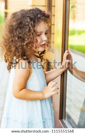 Little girl knocks on the closed door