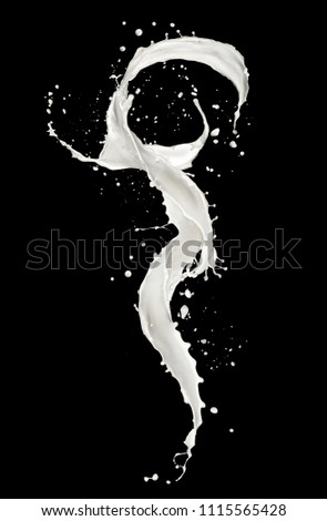 Abstract splash of milk isolated on black background. High resolution texture