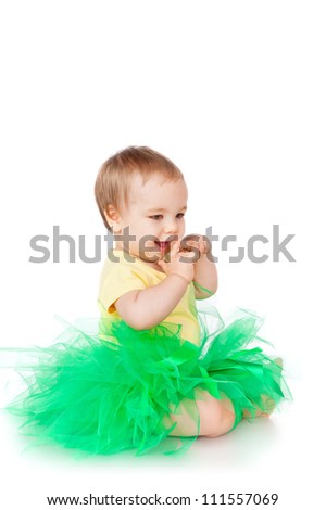 Cheerful little girl in a green skirt