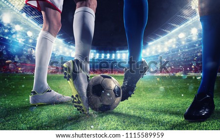 Soccer players with soccerball at the stadium during the match