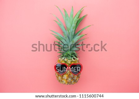 Table top view aerial image of summer & travel beach holiday in the season background concept.Flat lay sign objects on season.Pineapple wear red sunglasses on pink paper with word hello seasonal.