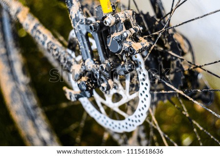 Rotor of Rear Hydraulic Brake on the Mountain Bike. Dirt on Mountain Bicycle Frame After the Race in Bad Weather