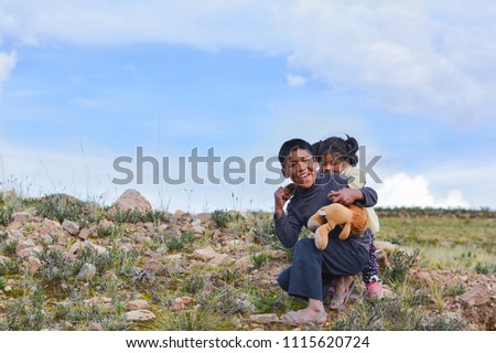Native american boy holding his little sister in the countryside. Royalty-Free Stock Photo #1115620724