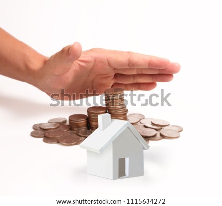 Money coin stack growing business in a hand and Model house