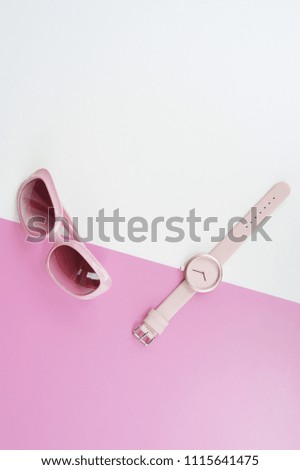 close up of wristwatches with sunglasses for background