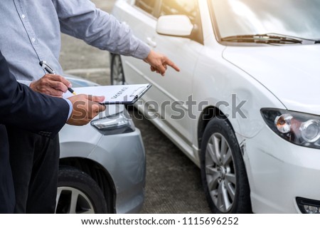 Insurance Agent examine Damaged Car and filing Report Claim Form after accident, Traffic Accident and insurance concept. Royalty-Free Stock Photo #1115696252