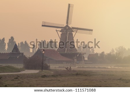 Dutch windmill on a foggy afternoon at the Zaanse Schans in Holland