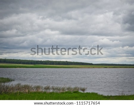 Summer landscape: a lake in cloudy weather