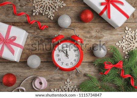 Flat lay composition with alarm clock on wooden background. Christmas countdown