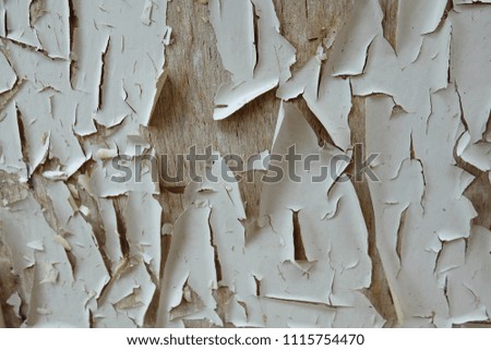 Old painted plastered wall with peeling paint. Abstract brown grunge plastered wall texture and background. Brown-white color. Many layers of paint