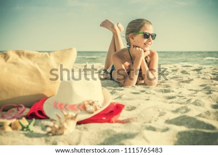 Cute white girl teenager resting on beach, summer background, selective focus, vintage style