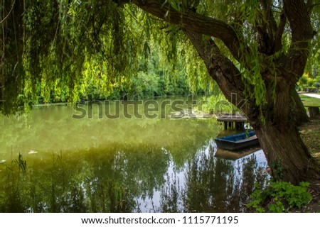 Spring on the river, calm water, pontoons and wooden boats