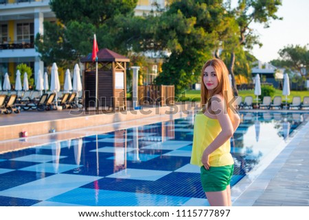 Luxury Resort. Woman Relaxing at sea. Beautiful Happy Healthy Female Model Enjoying Summer Travel Vacation, Looking At Sea View. Summertime Recreation, Relax And Spa Concept