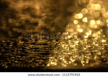 Water drop in sunlight background golden light, nature background free copy space.