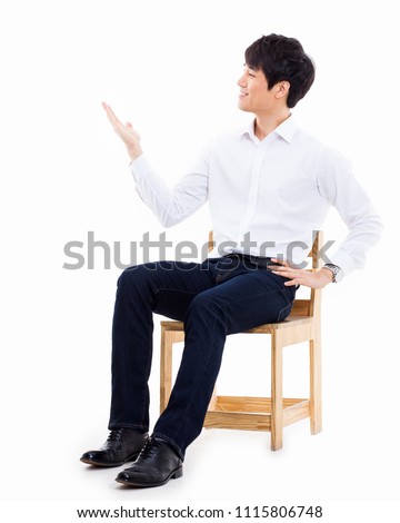 Asian man present something isolated on white background.