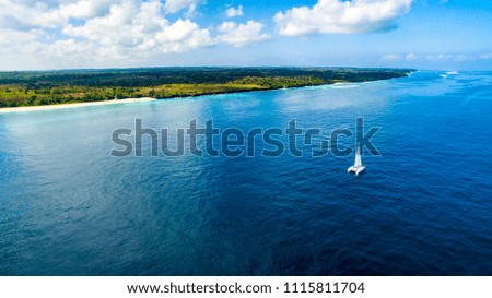  a catamaran sails off the coast of Sumba Indonesia 