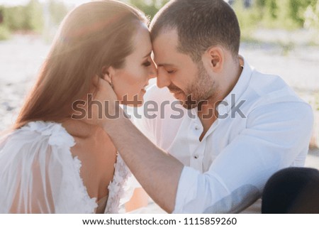 beautiful tender couple on beach with backlit