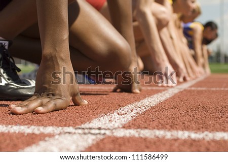 Female athletes at starting line Royalty-Free Stock Photo #111586499