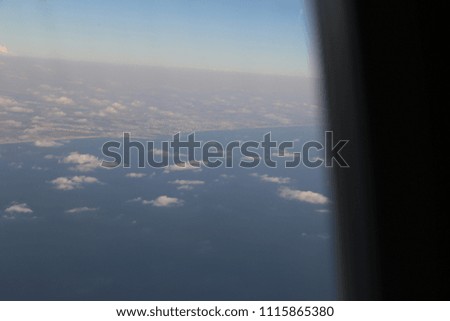 Blue sky and white clouds over the coast of the Mediterranean Sea, Tel Aviv, Israel. Taken from the window of a passenger airplane from above