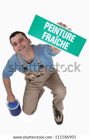 Man with a French wet paint sign