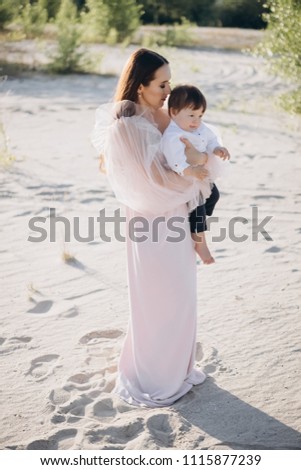 young mother holding little son on hands