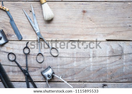 Old vintage barbershop tools on wooden table - barbershop background with copy-space