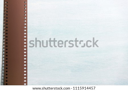 Film negative frames on textured blue background