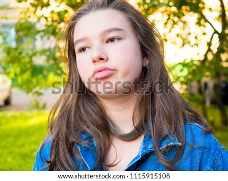 Thoughtful teenager girl portrait. Street photo