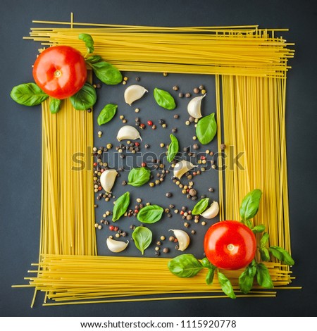 uncooked pasta, tomto an spieces as picture background, top view