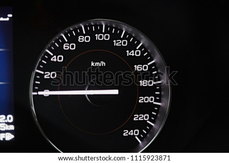 Instrument panel with speedometer. Close up image of illuminated car dashboard.