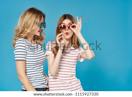  signs with fingers of a woman with glasses against a blue background                             